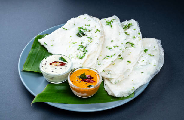 Freshly prepared traditional Neer Dosa arranged on a banana leaf