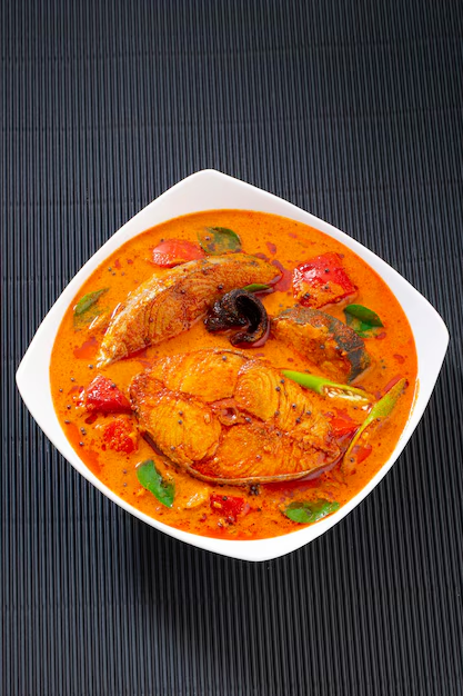 Traditional coastal fish curry cooked in earthen pots with fresh spices
